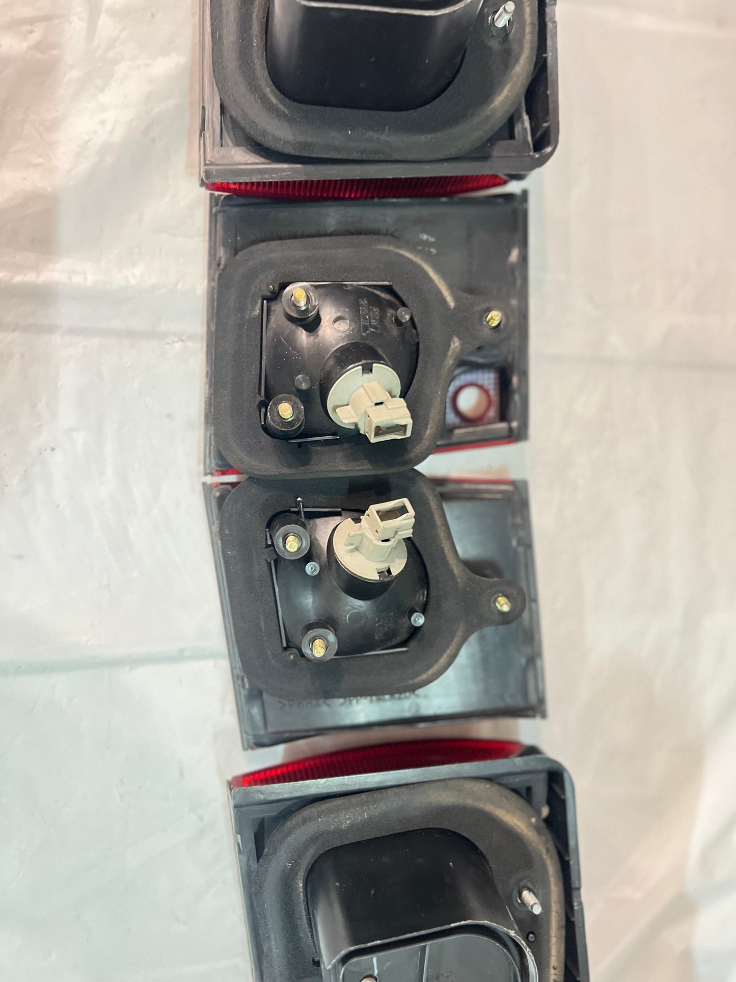 Mitsubishi Lancer Evolution 1-2-3 Tail Lights + rear reflector lights (discontinued item) sold as a set.